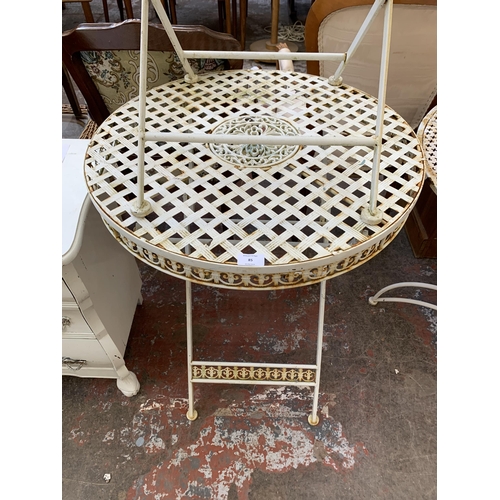 85 - A Victorian style white metal circular folding patio table and chair - approx. 77cm high x 63cm diam... 