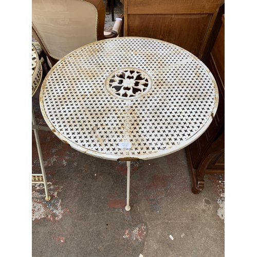 85A - A Victorian style white metal circular patio table - approx. 74cm high x 70cm wide