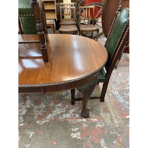 87 - A 19th century mahogany wind out dining table on ball and claw supports and four carved oak and gree... 