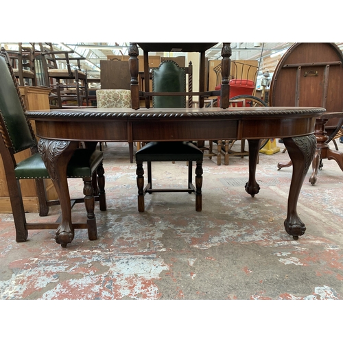 87 - A 19th century mahogany wind out dining table on ball and claw supports and four carved oak and gree... 