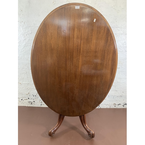 93 - A Victorian mahogany oval tilt top breakfast table on quatrefoil base - approx. 145cm high when tilt... 