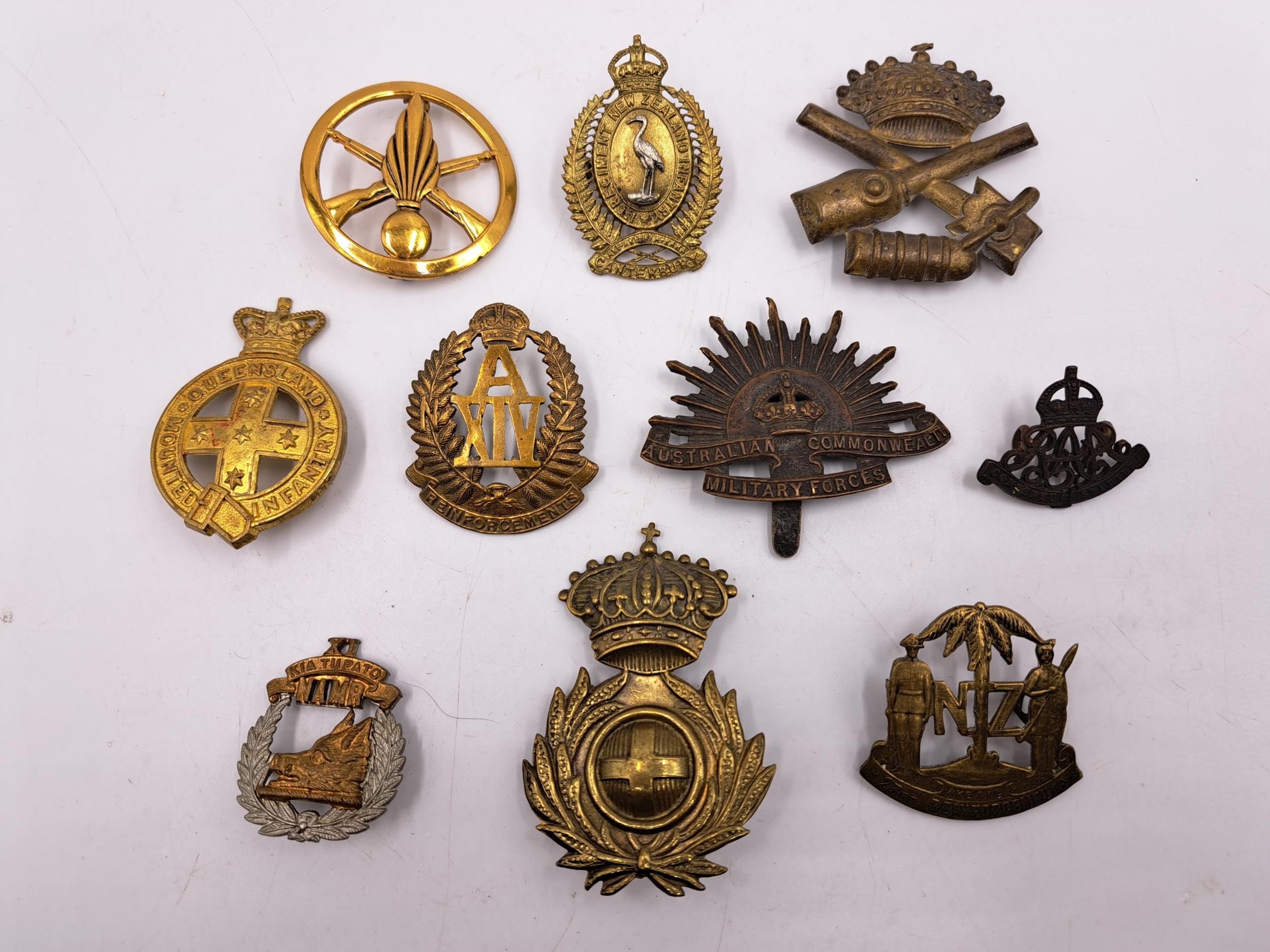 Ten military cap badges