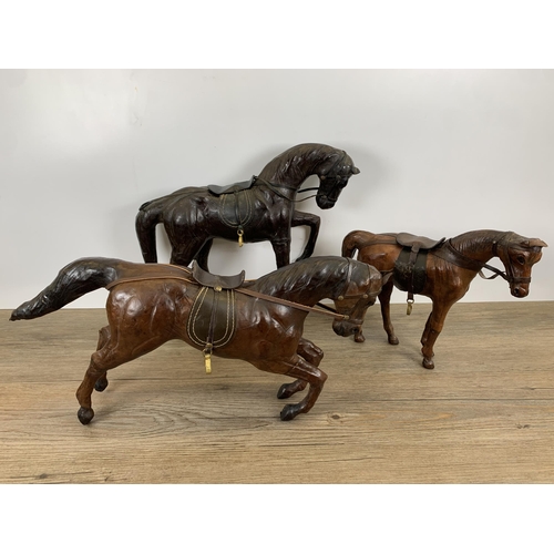 565 - Three vintage leather horse figurines - largest approx. 29cm high