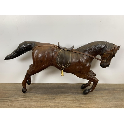 565 - Three vintage leather horse figurines - largest approx. 29cm high