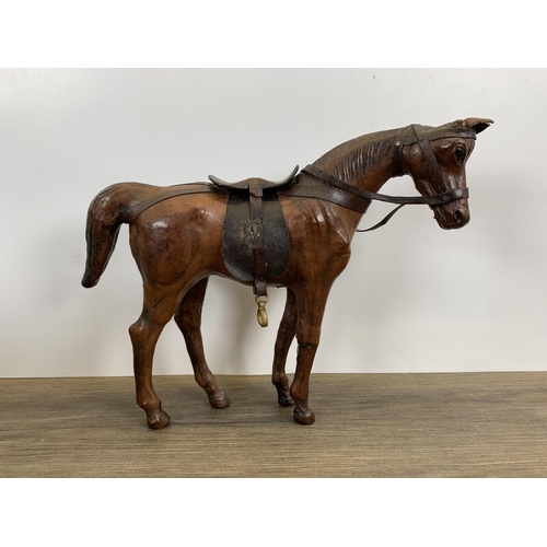 565 - Three vintage leather horse figurines - largest approx. 29cm high