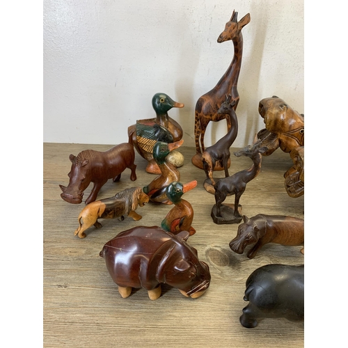 566 - A large collection of carved stone and treen animal figurines