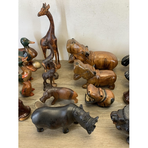 566 - A large collection of carved stone and treen animal figurines