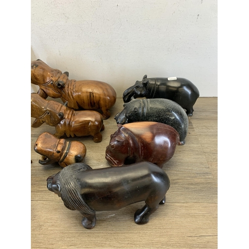 566 - A large collection of carved stone and treen animal figurines