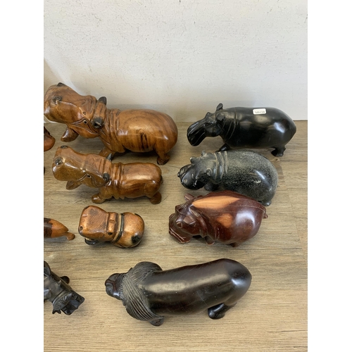 566 - A large collection of carved stone and treen animal figurines