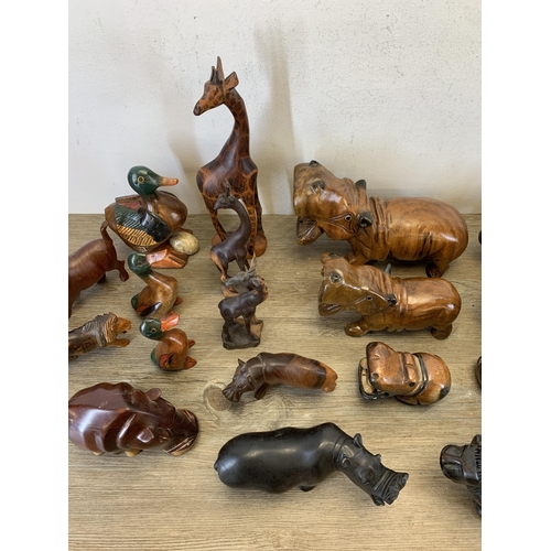 566 - A large collection of carved stone and treen animal figurines