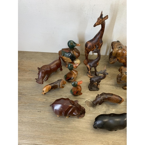 566 - A large collection of carved stone and treen animal figurines