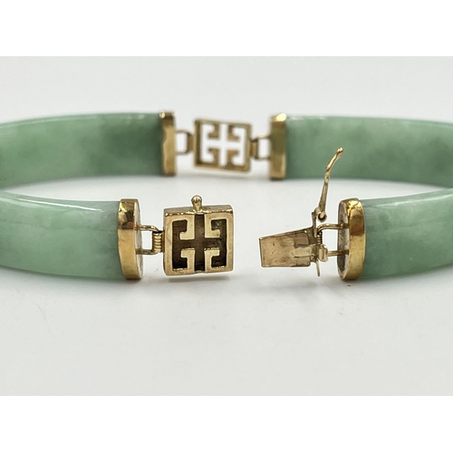 2235 - An Oriental yellow metal and jade panel bracelet - approx. gross weight 14.7g and 18cm long