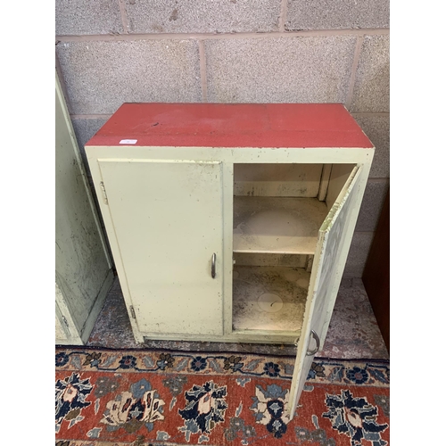 135A - A 1950s green painted and red laminate two door kitchen cabinet - approx. 75cm high x 65cm wide x 33... 