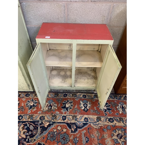 135A - A 1950s green painted and red laminate two door kitchen cabinet - approx. 75cm high x 65cm wide x 33... 