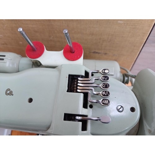 861 - A cased 1960 Singer 320K automatic-convertible swing-needle electric sewing machine with boxed stitc... 