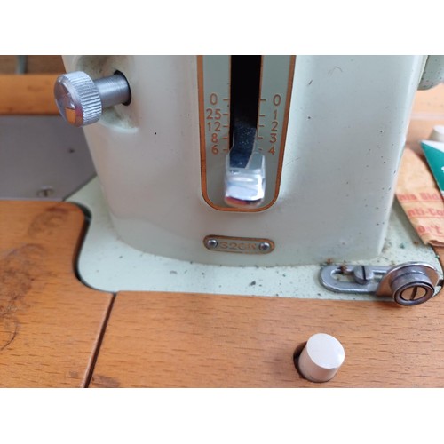 861 - A cased 1960 Singer 320K automatic-convertible swing-needle electric sewing machine with boxed stitc... 