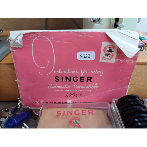 861 - A cased 1960 Singer 320K automatic-convertible swing-needle electric sewing machine with boxed stitc... 