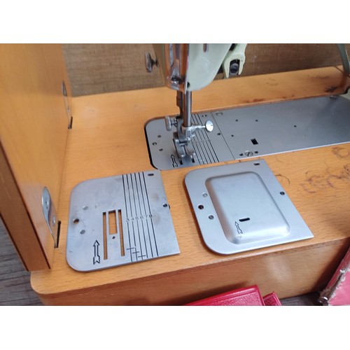 861 - A cased 1960 Singer 320K automatic-convertible swing-needle electric sewing machine with boxed stitc... 