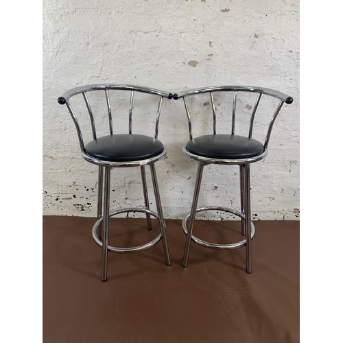 144 - A pair of modern black leatherette and chrome plated swivel kitchen barstools - approx. 90cm high x ... 