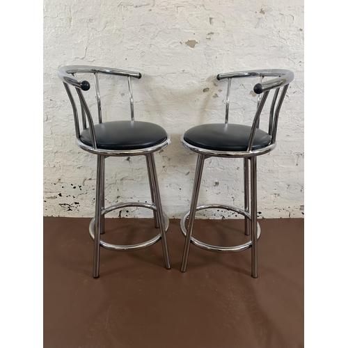 144 - A pair of modern black leatherette and chrome plated swivel kitchen barstools - approx. 90cm high x ... 