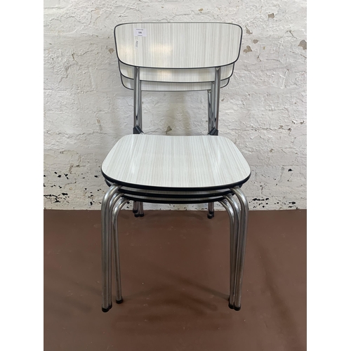 145 - Three mid 20th century white melamine and tubular metal stacking chairs