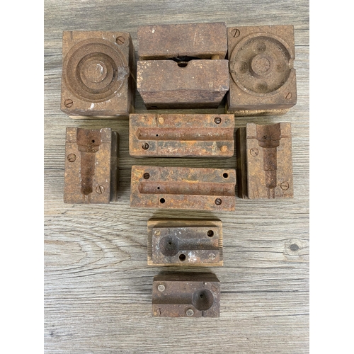 586 - A collection of early/mid 20th century cast iron factory machine part mouldings