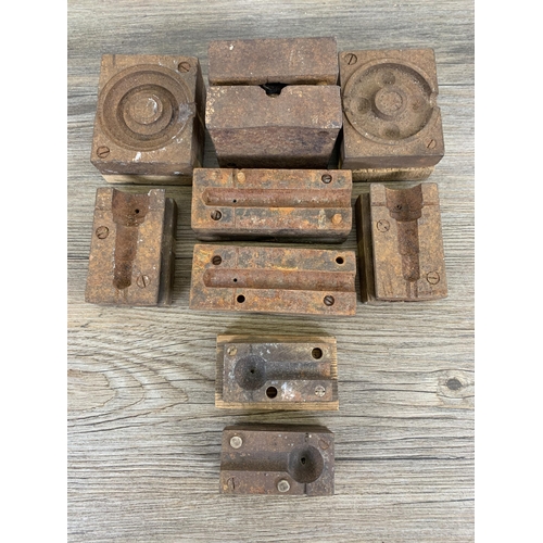 586 - A collection of early/mid 20th century cast iron factory machine part mouldings