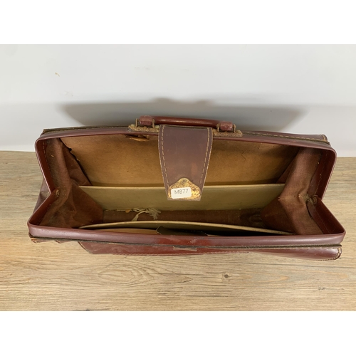 590 - A vintage Cheney brown leather Gladstone bag