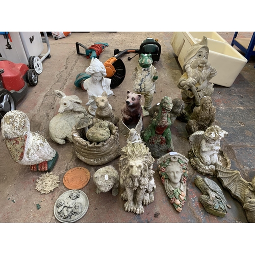 977 - A collection of garden ornaments to include cast stone, fibreglass etc.