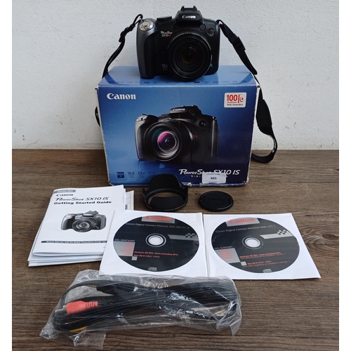 665 - A boxed Canon PowerShot SX10 IS 10mp digital camera with cable, software discs and instruction manua... 