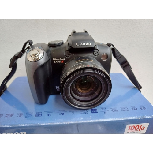 665 - A boxed Canon PowerShot SX10 IS 10mp digital camera with cable, software discs and instruction manua... 