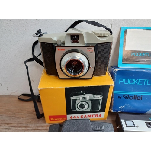 670 - A collection of boxed cameras and photography accessories to include Kodak Brownie 44A, Ihagee exten... 