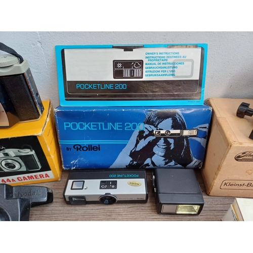 670 - A collection of boxed cameras and photography accessories to include Kodak Brownie 44A, Ihagee exten... 