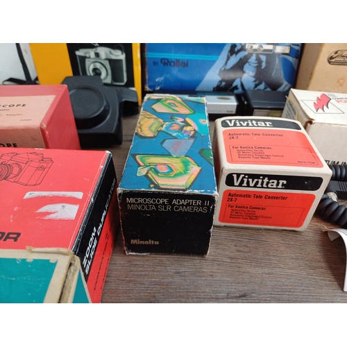 670 - A collection of boxed cameras and photography accessories to include Kodak Brownie 44A, Ihagee exten... 