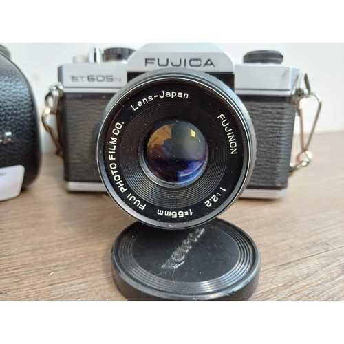 676 - A cased Fujica ST605N 35mm SLR camera fitted with Fujinon 1:2.2 f=55mm lens