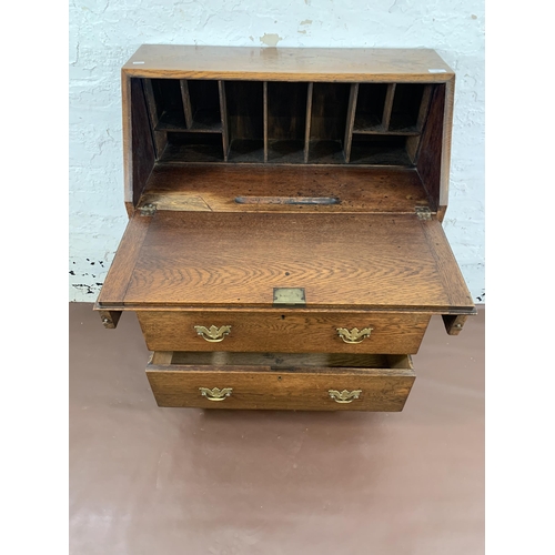 211 - A Georgian oak bureau on bracket supports - approx. 98cm high x 76cm wide x 39cm deep