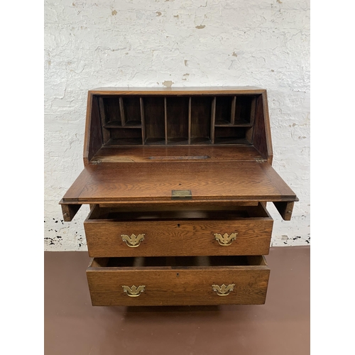 211 - A Georgian oak bureau on bracket supports - approx. 98cm high x 76cm wide x 39cm deep