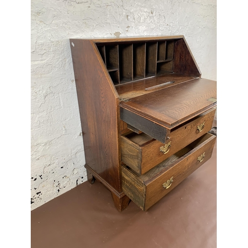 211 - A Georgian oak bureau on bracket supports - approx. 98cm high x 76cm wide x 39cm deep