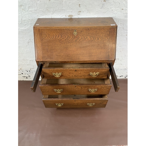 211 - A Georgian oak bureau on bracket supports - approx. 98cm high x 76cm wide x 39cm deep