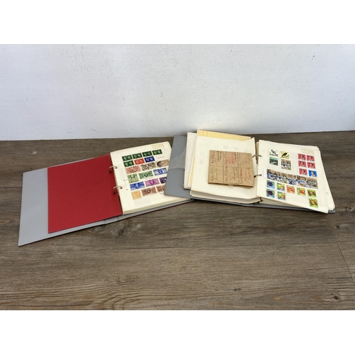 525 - Two stamp albums containing a collection of worldwide stamps to include three British seahorse stamp... 