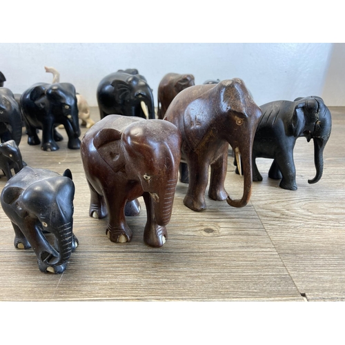 548 - A collection of approx. forty carved wooden and soapstone elephant figurines