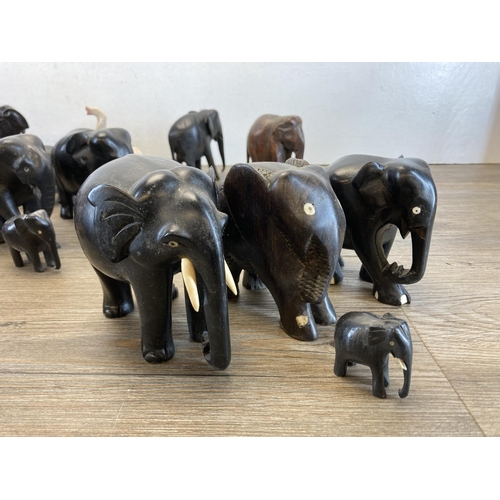 548 - A collection of approx. forty carved wooden and soapstone elephant figurines