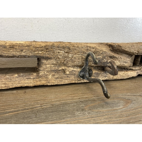 550 - Two rustic metal and wrought iron wall hanging coat hooks - largest approx. 116cm long