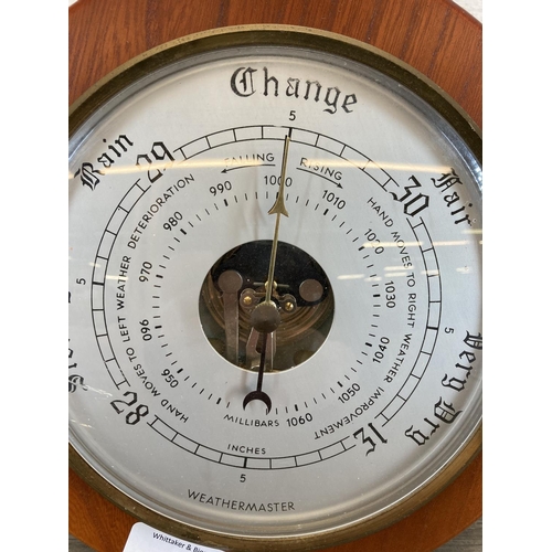 553 - A mid/late 20th century Weathermaster teak barometer - approx. 22cm diameter