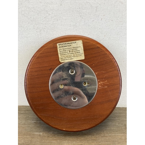 553 - A mid/late 20th century Weathermaster teak barometer - approx. 22cm diameter