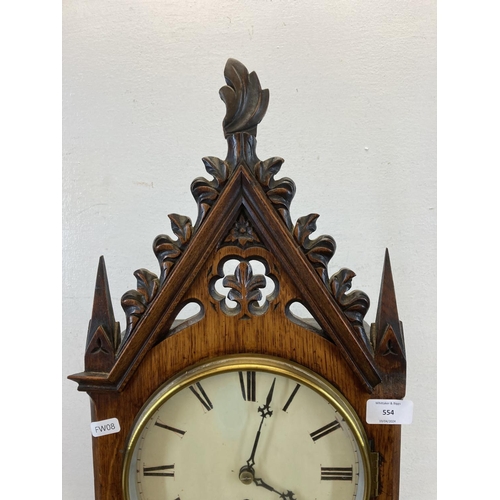 554 - A 19th century Gothic Revival oak cased fusee mantel clock with pendulum and key - approx. 61cm high... 