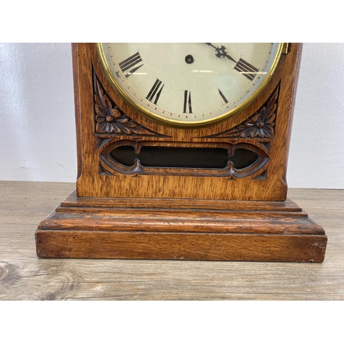 554 - A 19th century Gothic Revival oak cased fusee mantel clock with pendulum and key - approx. 61cm high... 