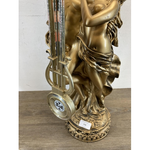 556 - A vintage W.M.Widdop gold painted figural mantle clock - approx. 75cm high