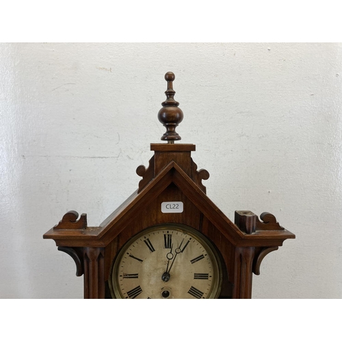 558 - A 19th century mahogany cased mantle clock with hand carved roundels, glass front and hand-painted d... 