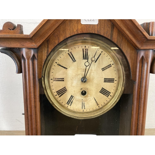 558 - A 19th century mahogany cased mantle clock with hand carved roundels, glass front and hand-painted d... 